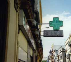 Spanish farmacias (pharmacies) are marked with green crosses.